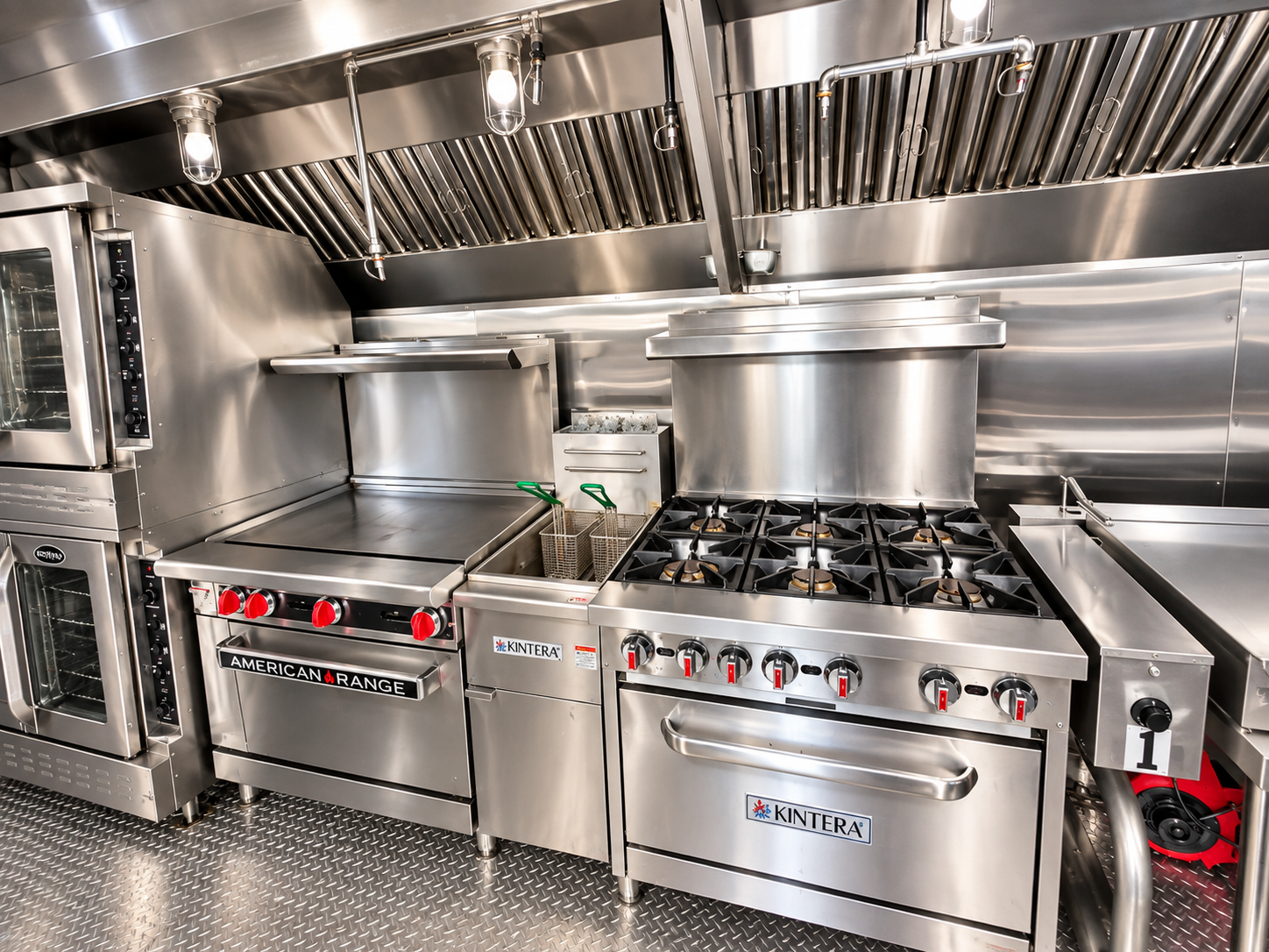 Range, griddle and fryer cooking line inside a 40 ft bulk kitchen trailer